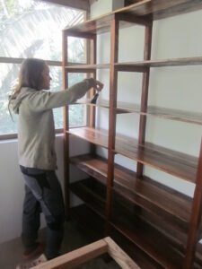 Mara painting the shelves